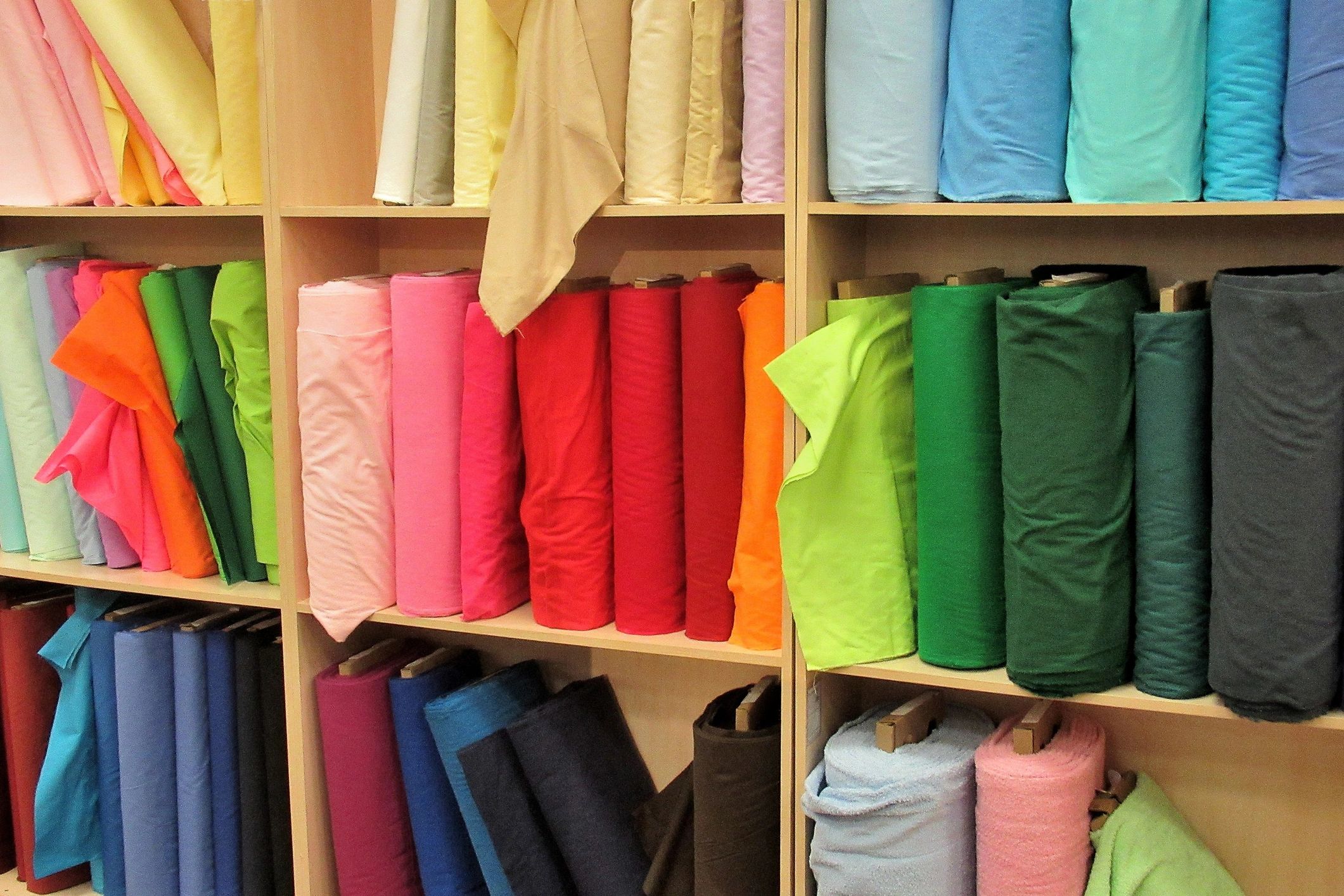 Colorful fabric rolls on a shelf